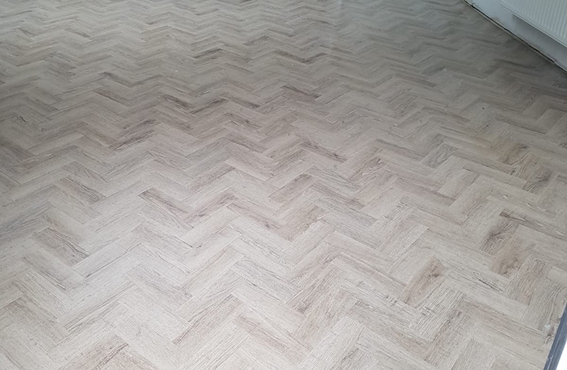 Luxury vinyl tile in herringbone