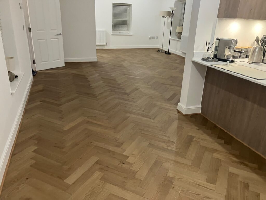 Ted Todd Husk engineered oak herringbone in an open-plan kitchen and living room in Parbold